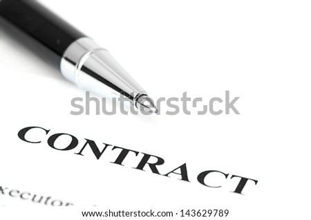 Close-up of silver pen on contract.