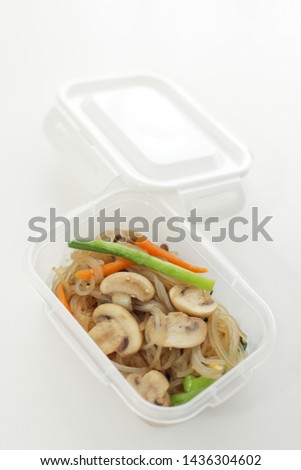 Korean food, mushroom and sweet potato noodle stir fried Japchae in plastic box for stock food image