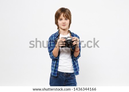 Fun little kid boy in blue t-shirt hold retro vintage photo camera, doing photo shot isolated on white wall background children studio portrait. People childhood lifestyle concept. Mock up copy space