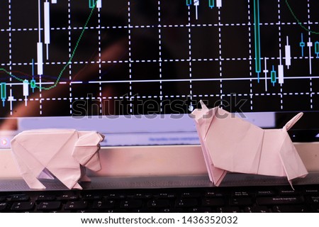 origami bear and origami bull against the background of the trader's graphics