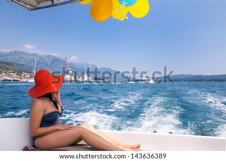 Woman sailing in a yacht on her summer holidays