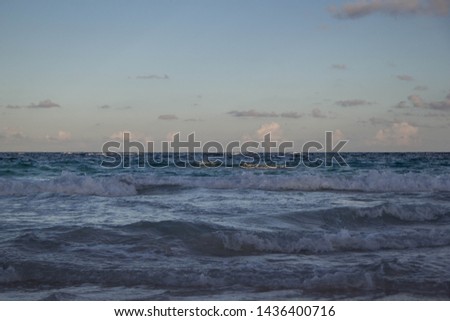 Ocean Waves Splashing On The Beautiful Wide Bermuda Beach In Sunset