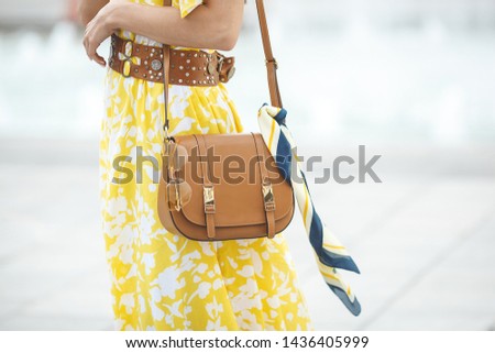 Women accessories closeup picture. Purse, sunglasses and the 
kerchief. Brown handbag with fashion details.