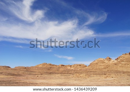 
Bright blue sky over a desert valley among mountains