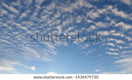 Celestial sky with clouds in line with central point