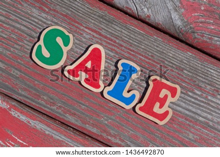 word sale made of wooden letters on wooden board
