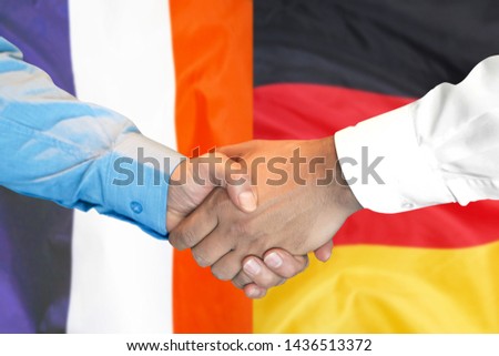 Business handshake on the background of two flags. Men handshake on the background of the France and Germany flag. Support concept