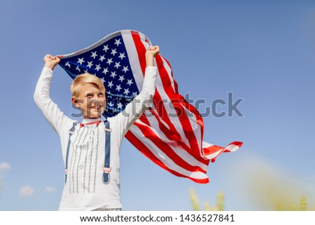 Patriotic holiday. Boy holding American flag. Patriots of America. Independence day, 4th of july .