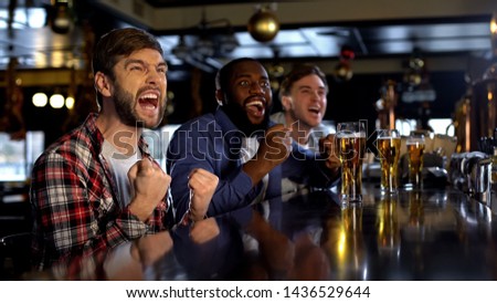 Excited multiethnic friends supporting sports team, victory of national team Royalty-Free Stock Photo #1436529644