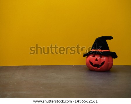 Halloween holiday ideas, pumpkin decorations yellow background.