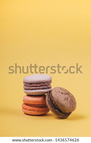 Close up colorful set of macaron on yellow background. Traditional french dessert. Sweet delicious food