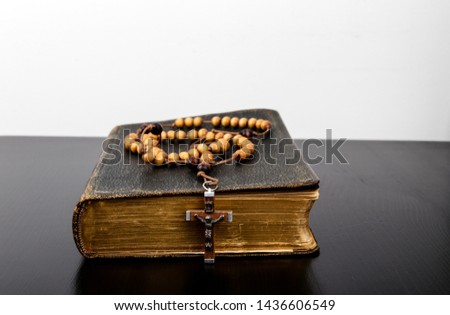 Rosary beads and prayer book. Rosary and book of Catholic Church liturgy.