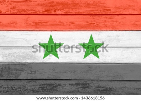 The national flag of Syria is painted on old scratched boards. Watercolor effect. Can be used as a background.