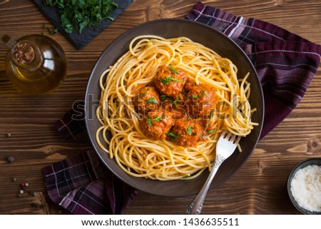 Spaghetti and meatballs, delicious italian basta mith tomato sauce in a brown plate