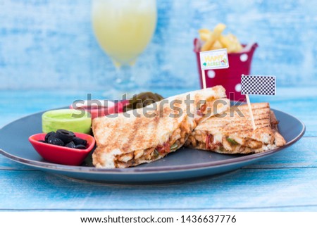 Stock Photo of Grilled Chicken Sandwich  in a grey plate with ketches 