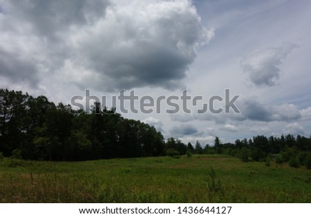 Rural Scene with Mountains and Cloudy Sky