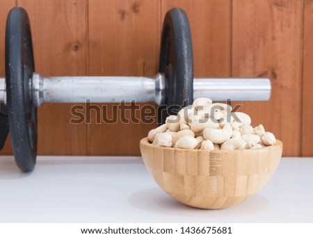 Cashews with a dumbbell behind