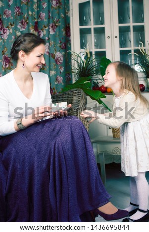 young mother with daughter at luxury home interior vintage
