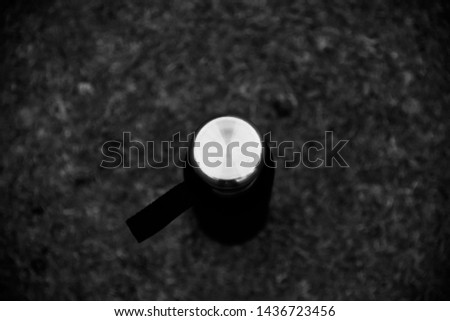 Isolated metallic cap of a water bottle black and white photo