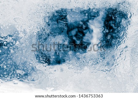 Ice texture background. Textured frosty surface of ice blocks against black.