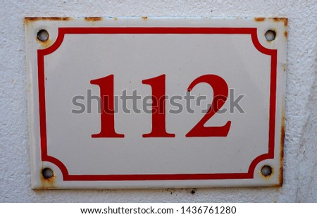 Number one hundred and twelve on metal plate