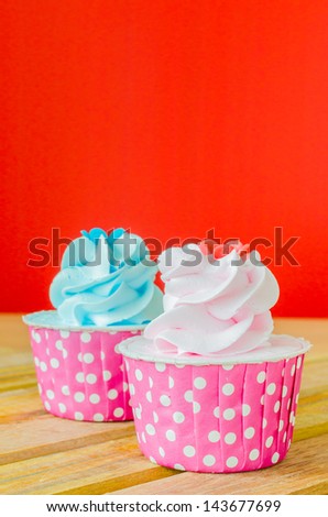 Two Cupcake on color background