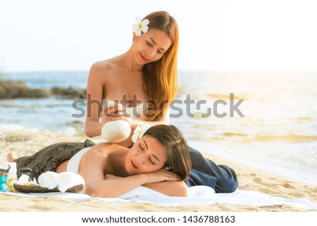 Asian woman are happy and relaxed massage at a spa on the beach in the evening.