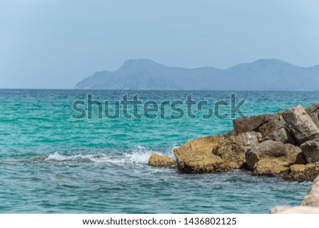 Rock in blue sea with Mountain coastline on mallorca island