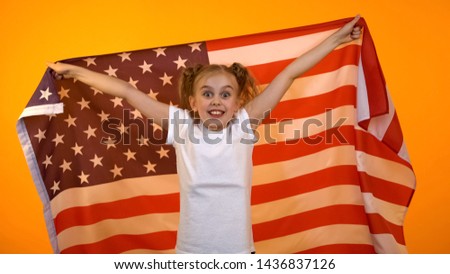 Emotional preteen girl holding american flag, supporting national team in match
