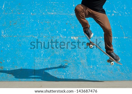 Skateboarder doing a skateboard trick - ollie - at skate park. Royalty-Free Stock Photo #143687476