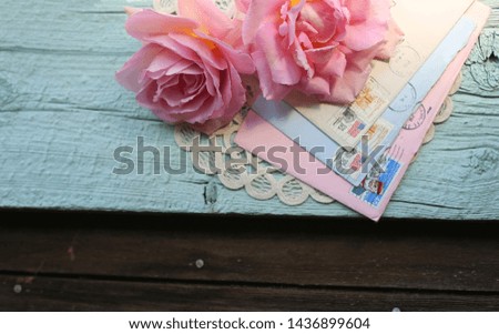 Pink roses, love letters and lace on a rustic background