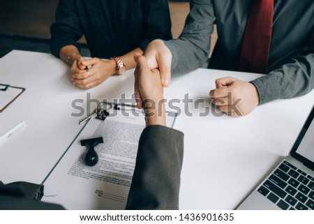 Real estate agents handshake with customers after selling houses, real estate concept.
