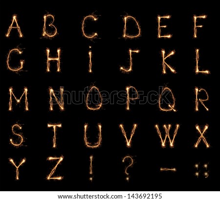 Alphabet sparklers on black background