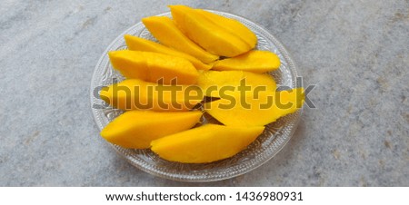 Mango fruit or mango slices on transparent plate with colorful background