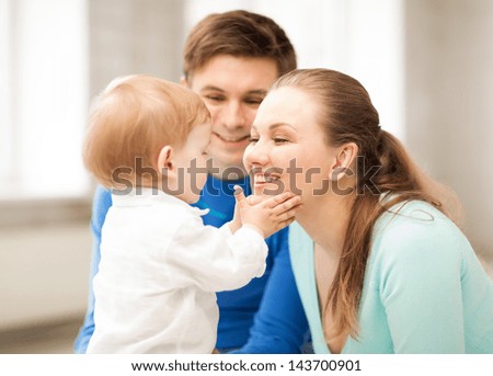 picture of happy parents playing with adorable baby