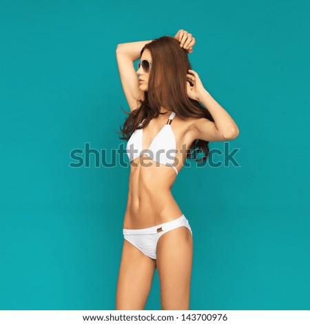 picture of model posing in white bikini with shades