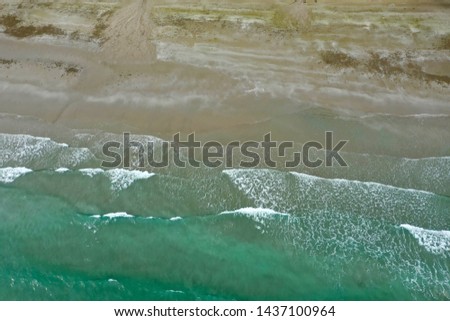 Emerald green, blue water at the beach and splashing on the beach for Catalogs, background, wallpaper,  patterns and texture, vacation catalog top view with aerial photography