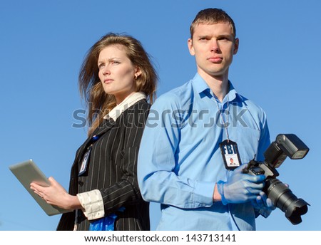 Two young criminalists on a sky background