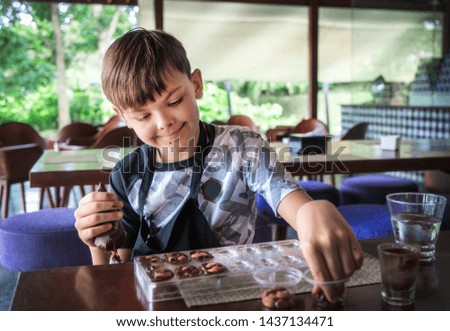 Handsome boy at a chocolate factory making candy. Bali. Indonesia, 