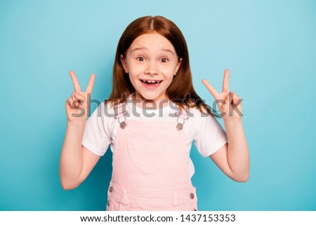 Portrait of cheerful cute kid make v-signs two laugh laughter isolated blue background