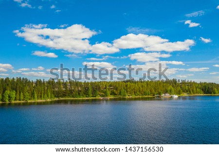 Landscape of island, lake and forest in Imatra. Blue sky and clouds.Finland