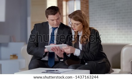 Agent of real estate showing photos on tablet, convincing investor to buy office