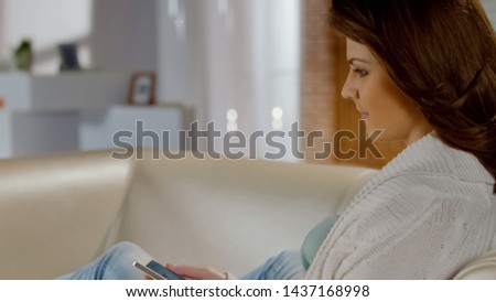 Attractive girl choosing purchase on cellphone, online shopping application
