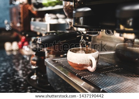 A cup of cappuccino coffee or latte coffee in a white cup with laptop on table. Royalty high quality free stock photo of drink capuccino or latte coffe