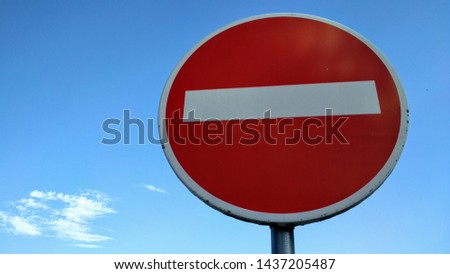 Red and white Forbidden traffic sign on a pole next to the road in urbanization