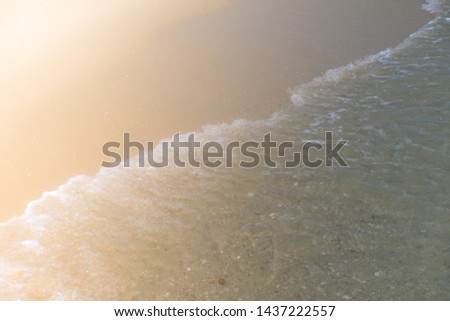 Beach top view with wave foam. Stock photo image of blue color of ocean water, sea surface. Soft blue ocean wave on sandy beach, turquoise waves, clear water surface texture. Nature background