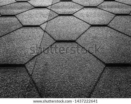 Black and white photo of soft shingles tiles closeup. The texture of the roof of the roof, made of shingles. The texture of shingles. Background on the topic of roofing construction materials. Royalty-Free Stock Photo #1437222641