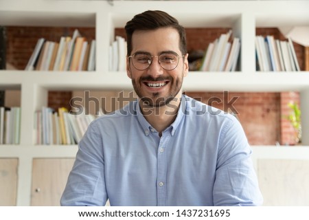 Happy male coach teacher webinar speaker looking at camera giving online class lecture or making conference video chat call, smiling businessman entrepreneur recording video training, webcam view Royalty-Free Stock Photo #1437231695