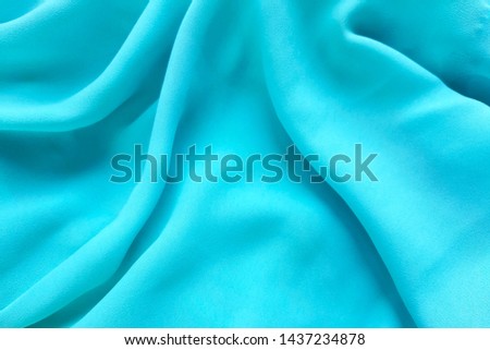 Drapped blue soft silk background.  Pretty wedding or celebration decorative concept. 