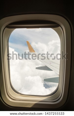 Looking out the window of a plane at the clouds 